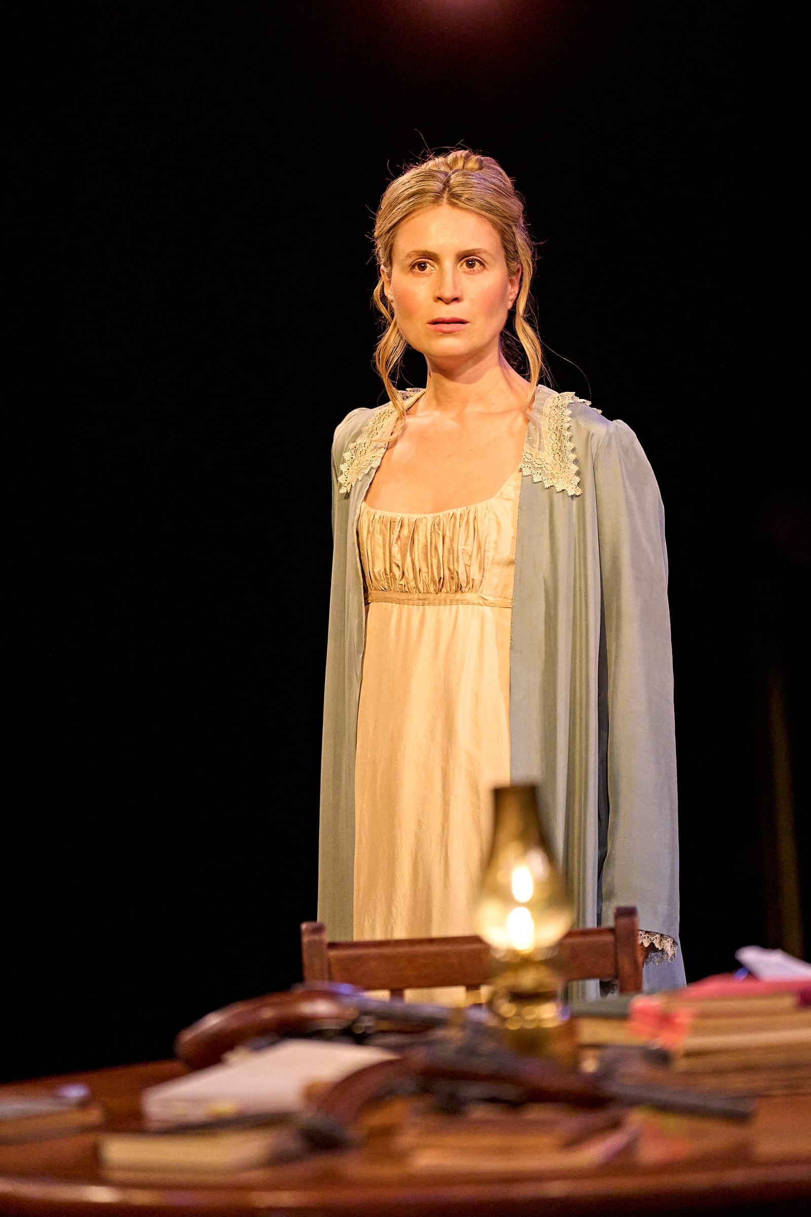 Woman standing behind a table on the Arcadia stage