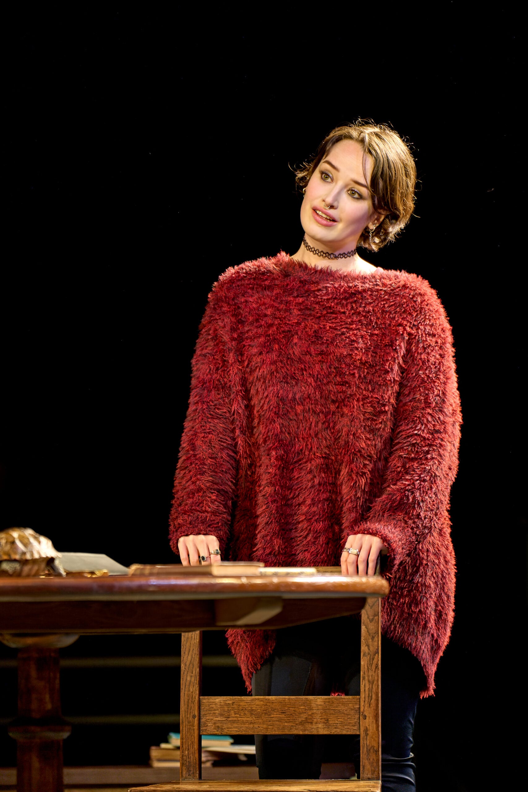 Woman in a red fuzzy sweater on the Arcadia stage