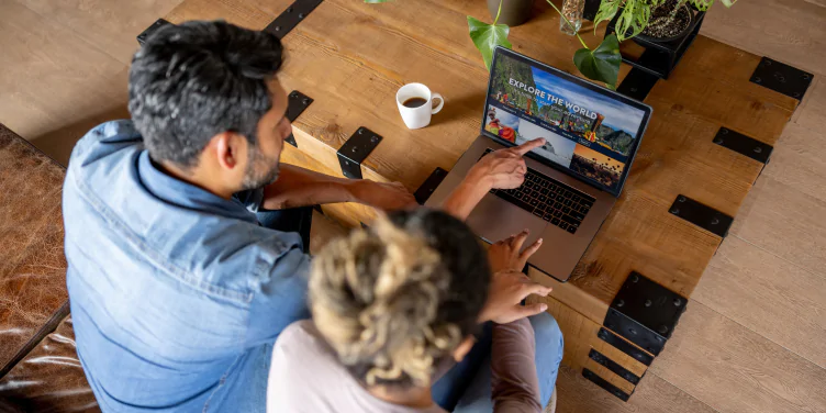 Couple planning a holiday together on a laptop