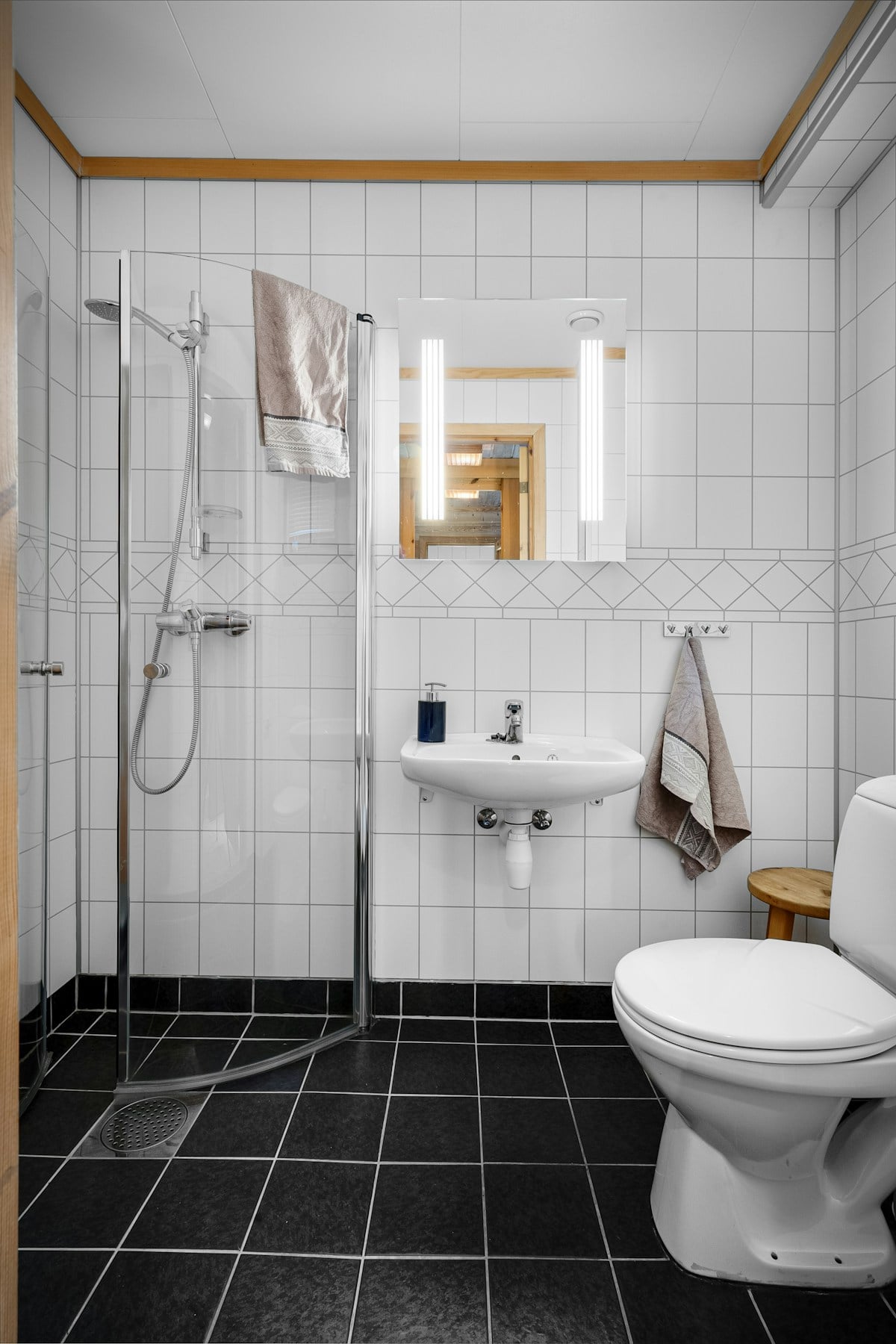 Illuminated mirror above a contemporary bathroom basin
