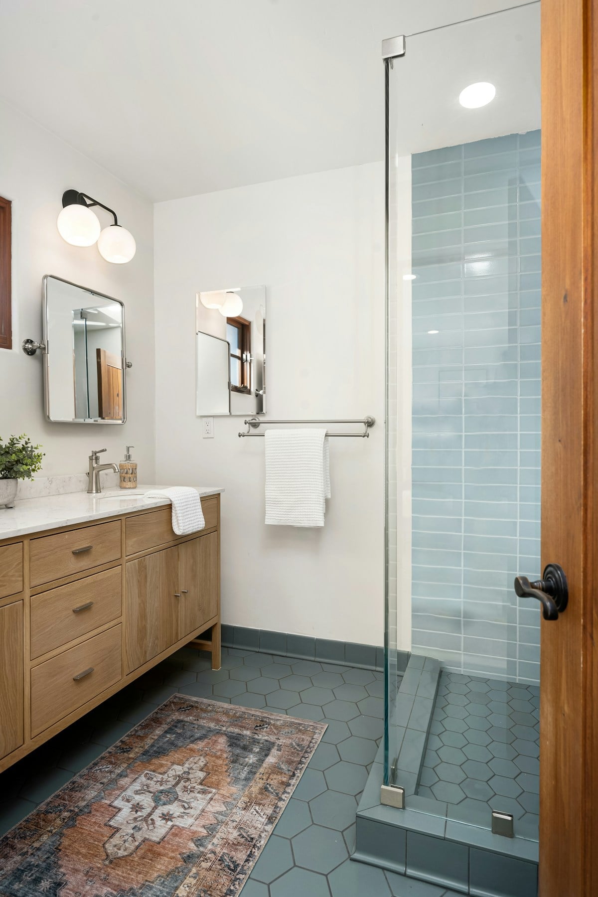 Light-filled bathroom with a mirrored cabinet and hanging towel