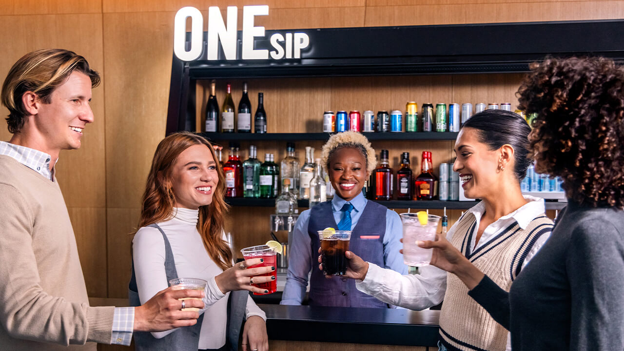 Guests holding drinks at ONE Dine