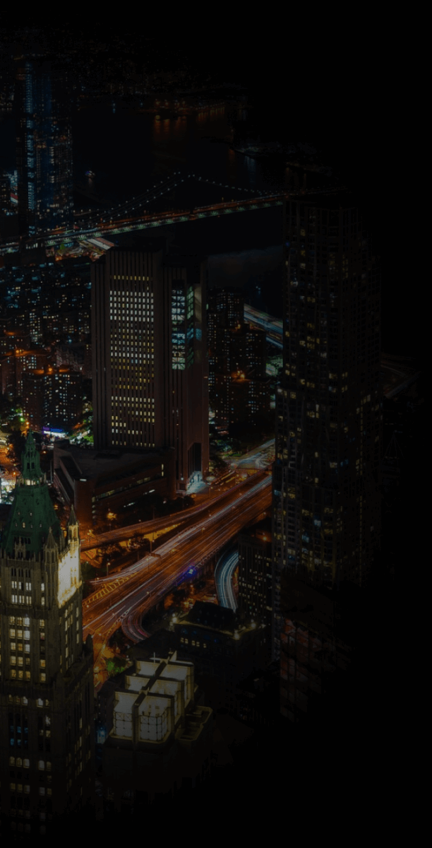 Nighttime aerial view of Lower Manhattan and the Brooklyn Bridge