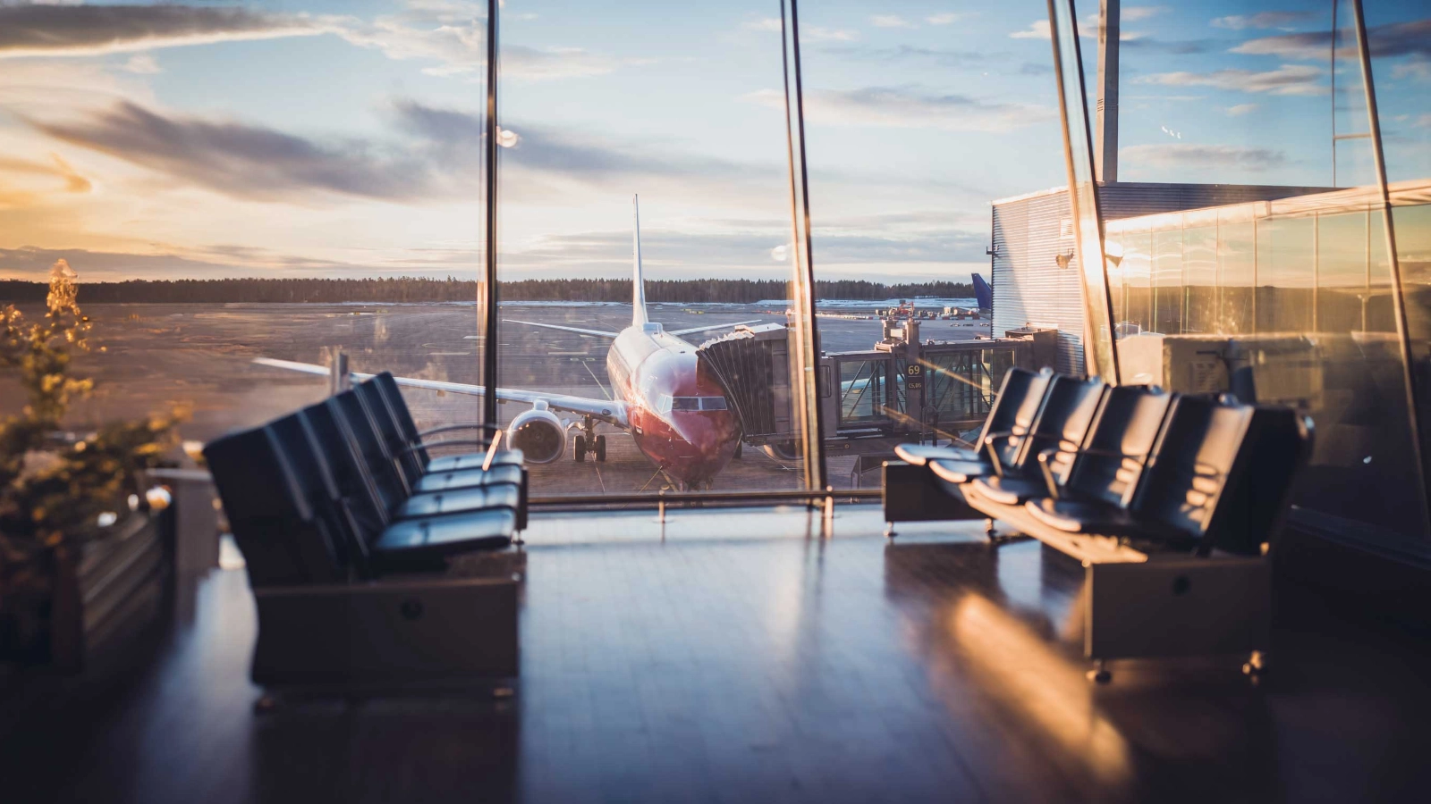 Airplane parked outside an airport departure lounge