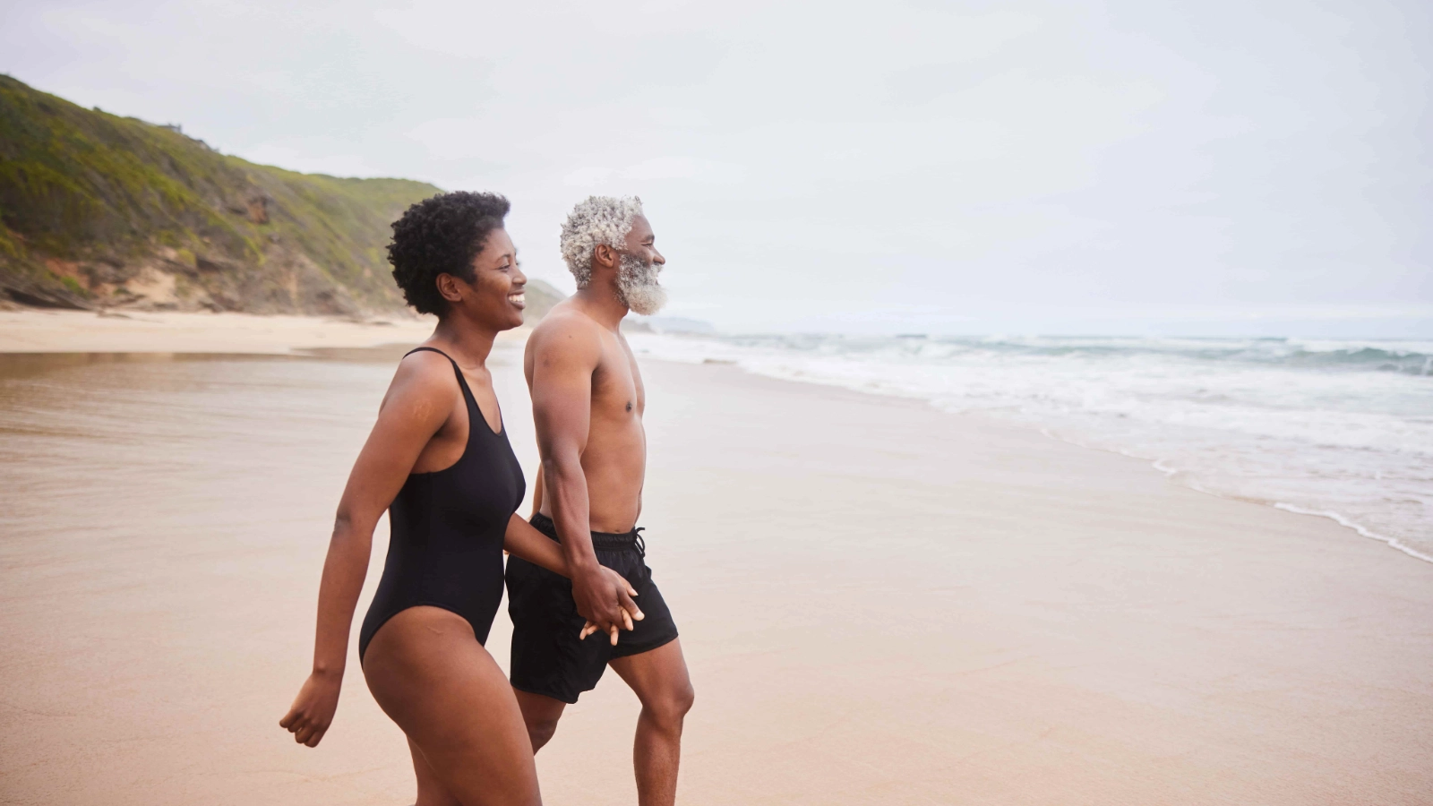Couple over 50 holding hands outdoors