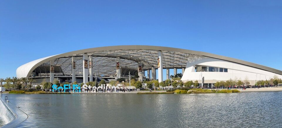 SoFi Stadium exterior with its curved roof and reflecting pool