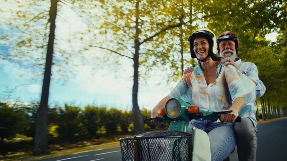 Traveller riding a moped on holiday