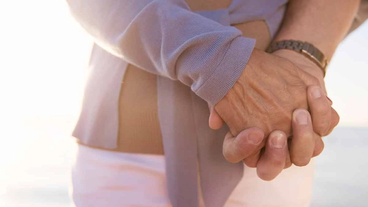 Two people holding hands while travelling