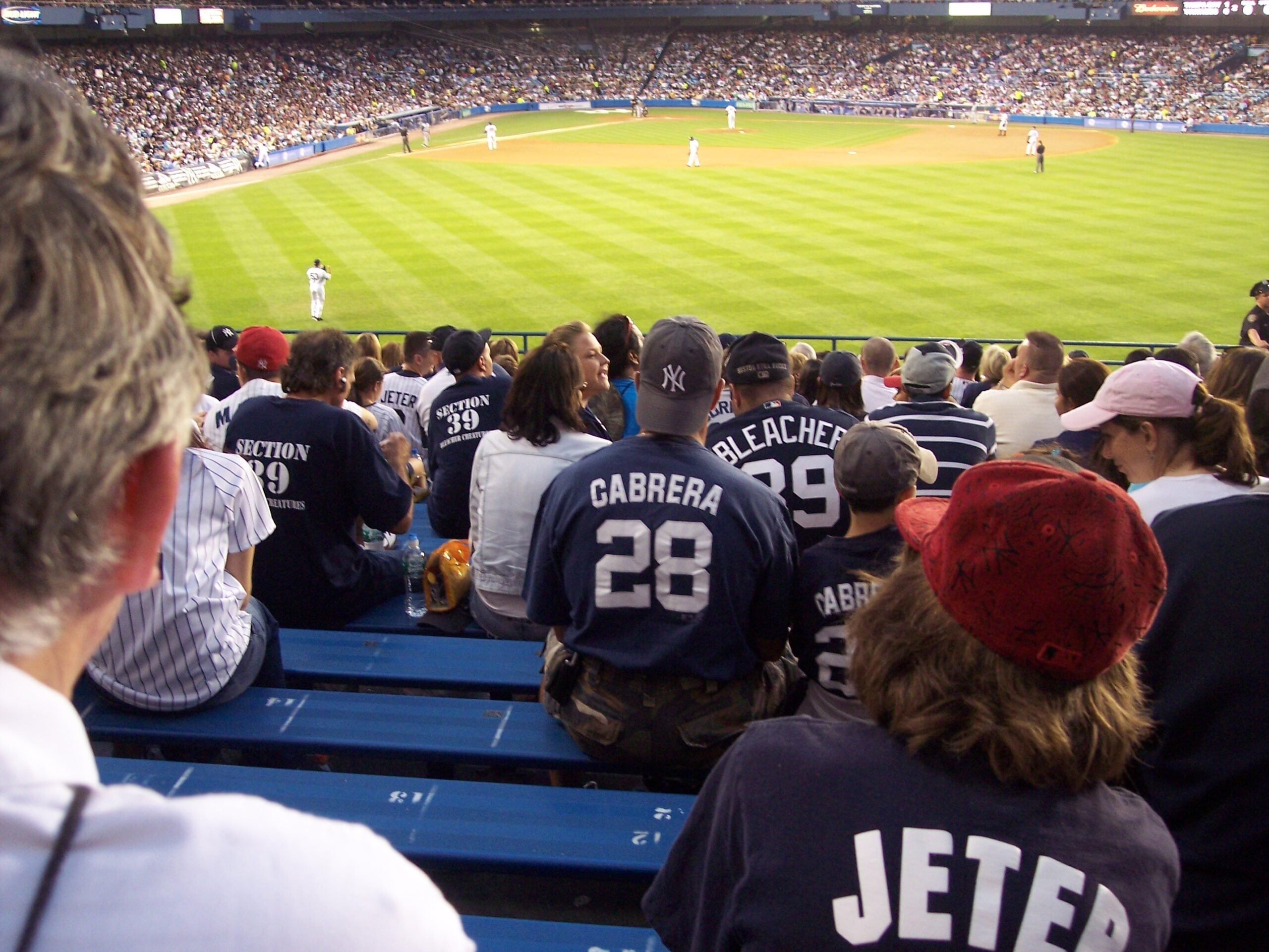 Yankees fans cheering together in the bleachers