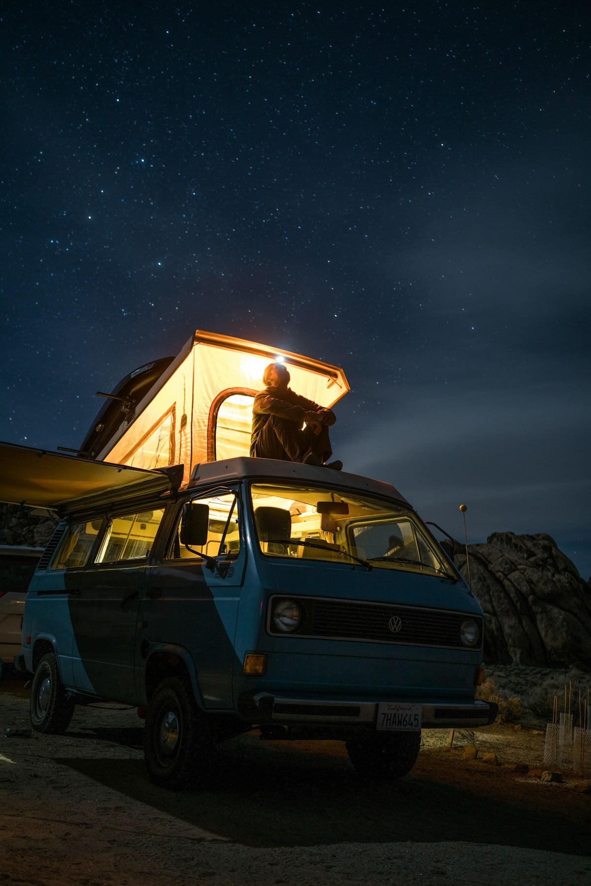 Camper van beneath a starry night sky