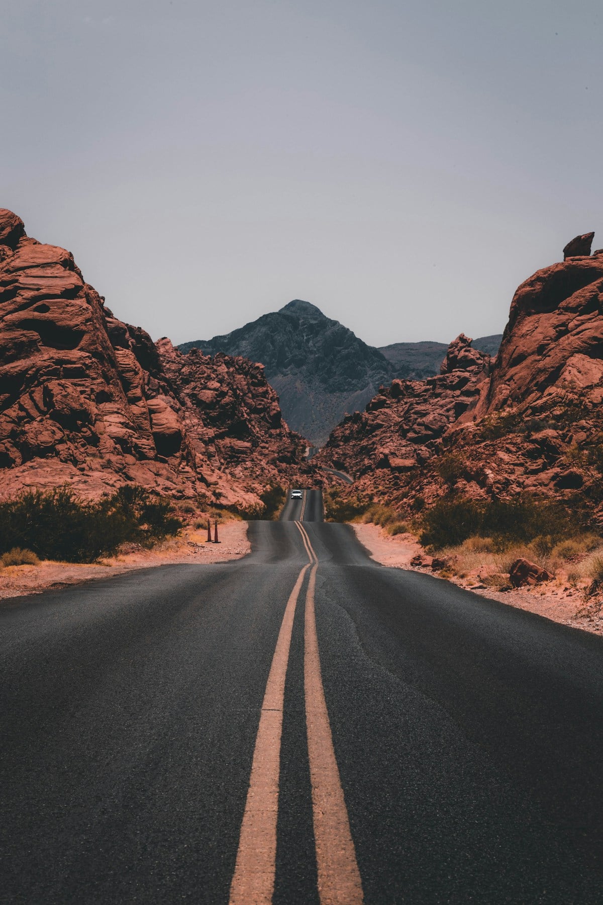 Mountain road opening into a travel landscape