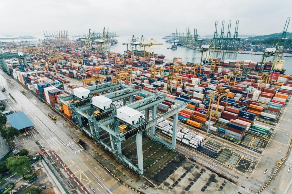 Shipping containers at a busy travel logistics port