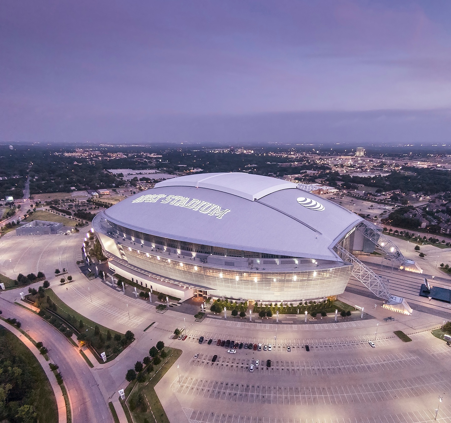 AT&T Stadium illuminated at night from above