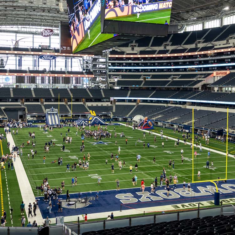 Fans enjoying Rally Days activities on the field at AT&T Stadium