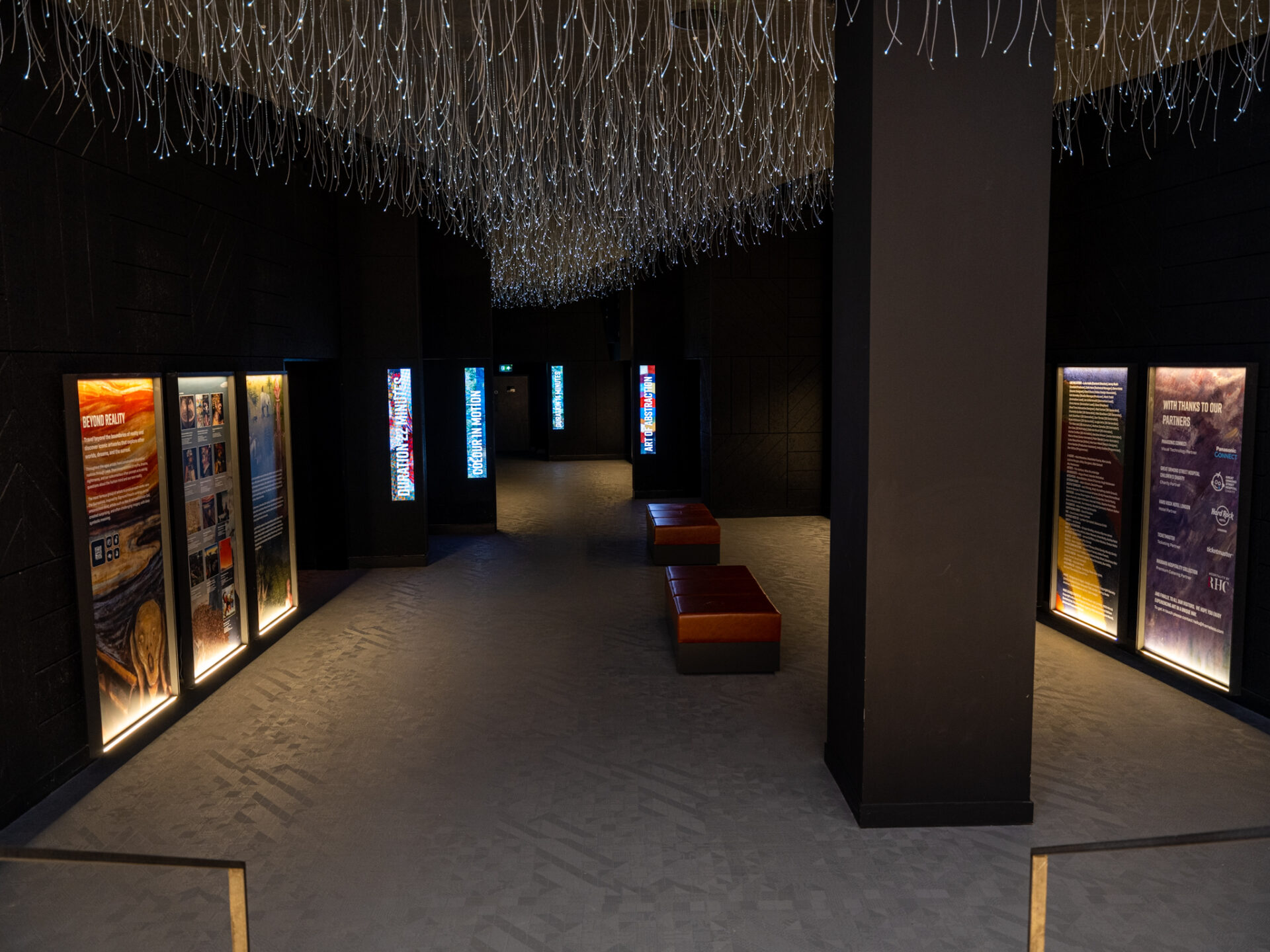 Dark gallery with information panels at Frameless