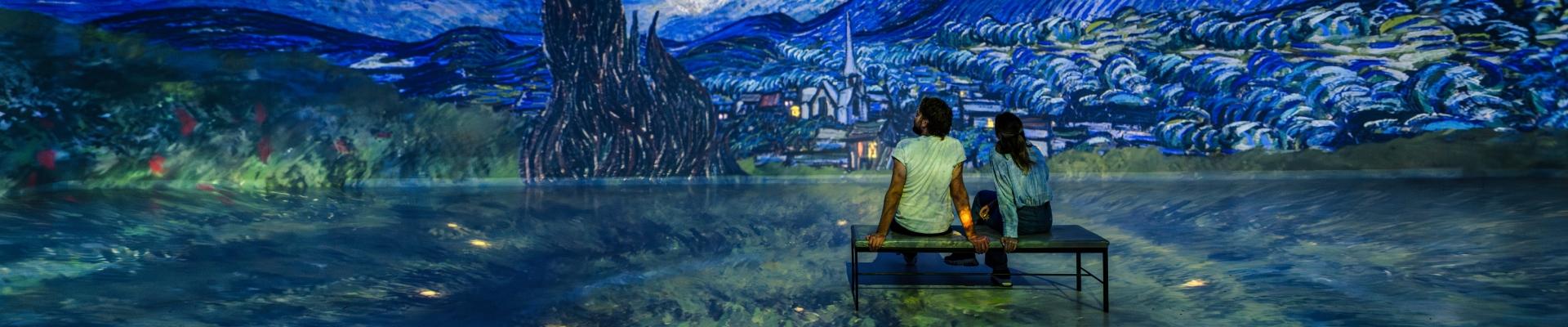 Visitors sitting inside The World Around Us gallery at Frameless