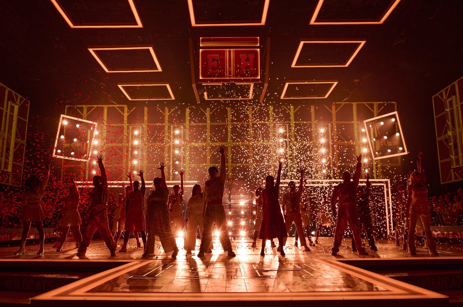 High School Musical performers gathered in a dramatic scene
