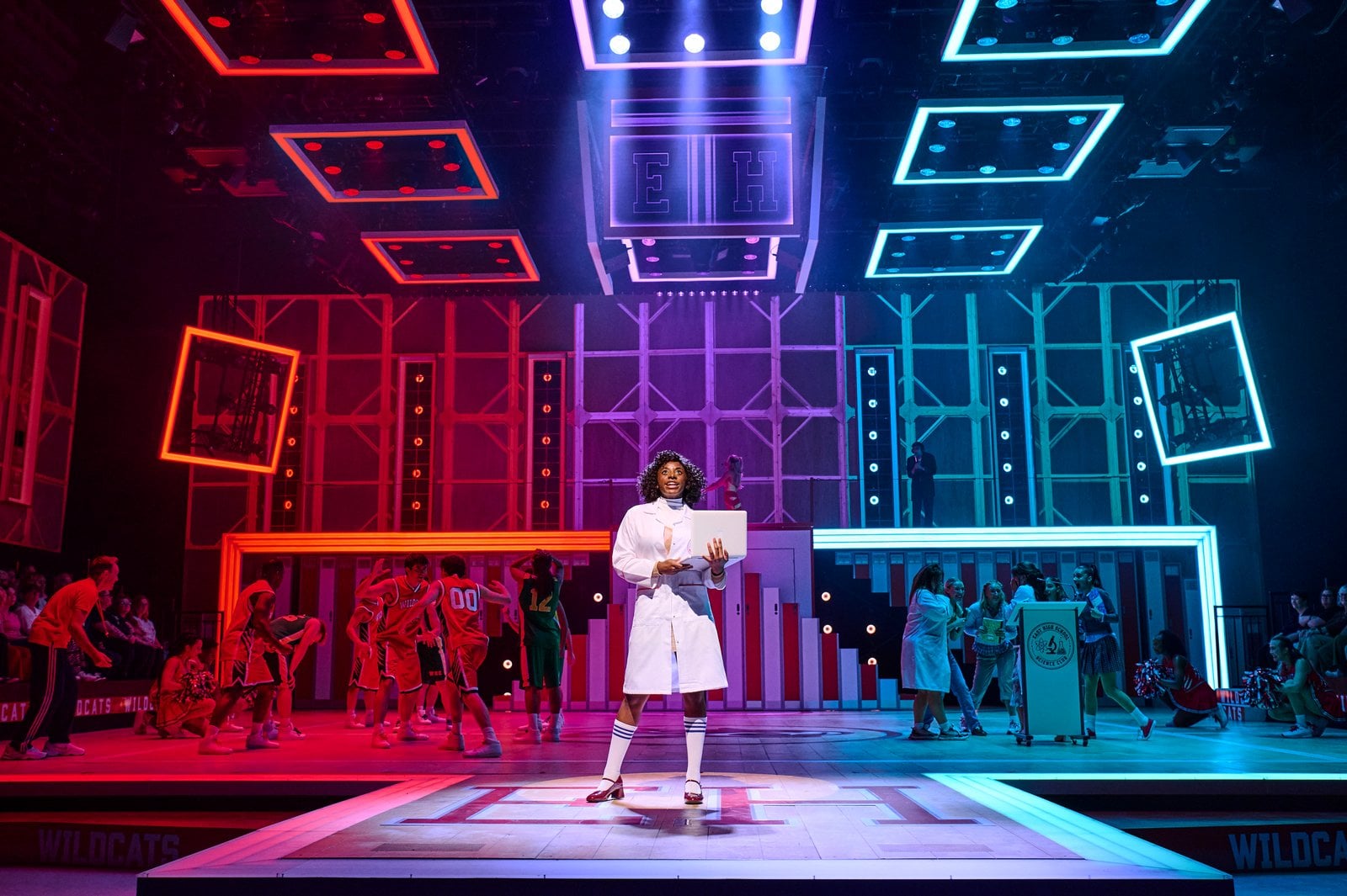 High School Musical cast members rehearsing on stage