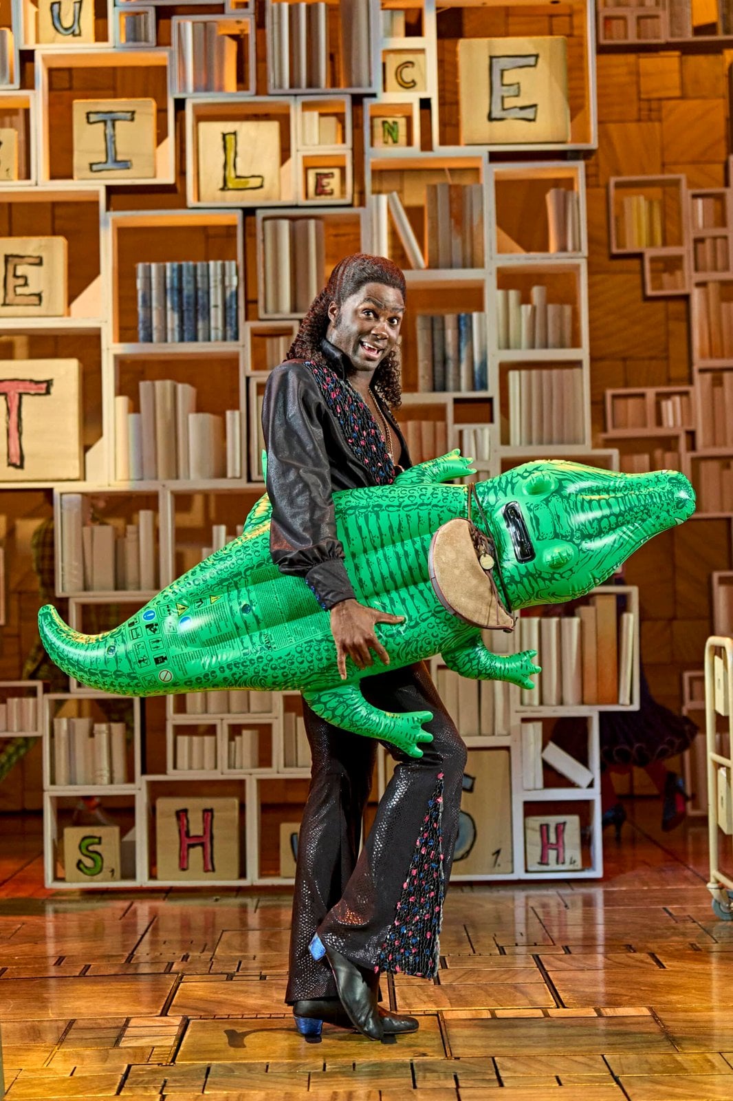 Matilda The Musical performer with an inflatable crocodile