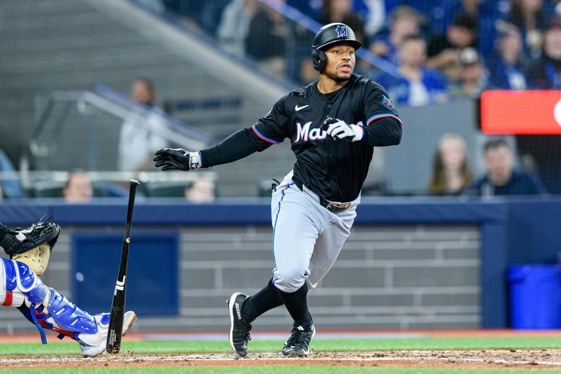 Miami Marlins player running after a hit during a game