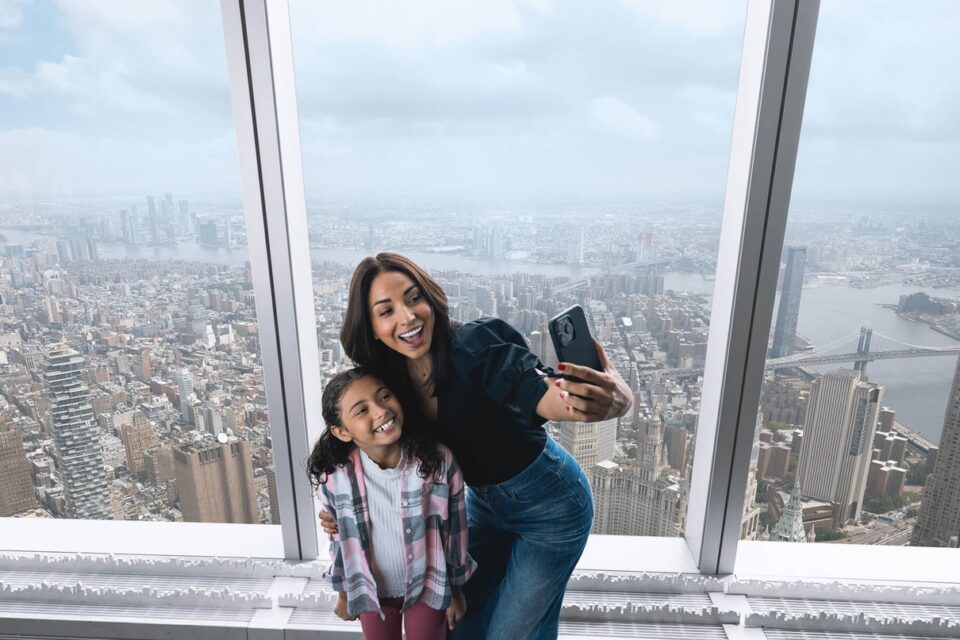 Family looking out over New York from One World Observatory