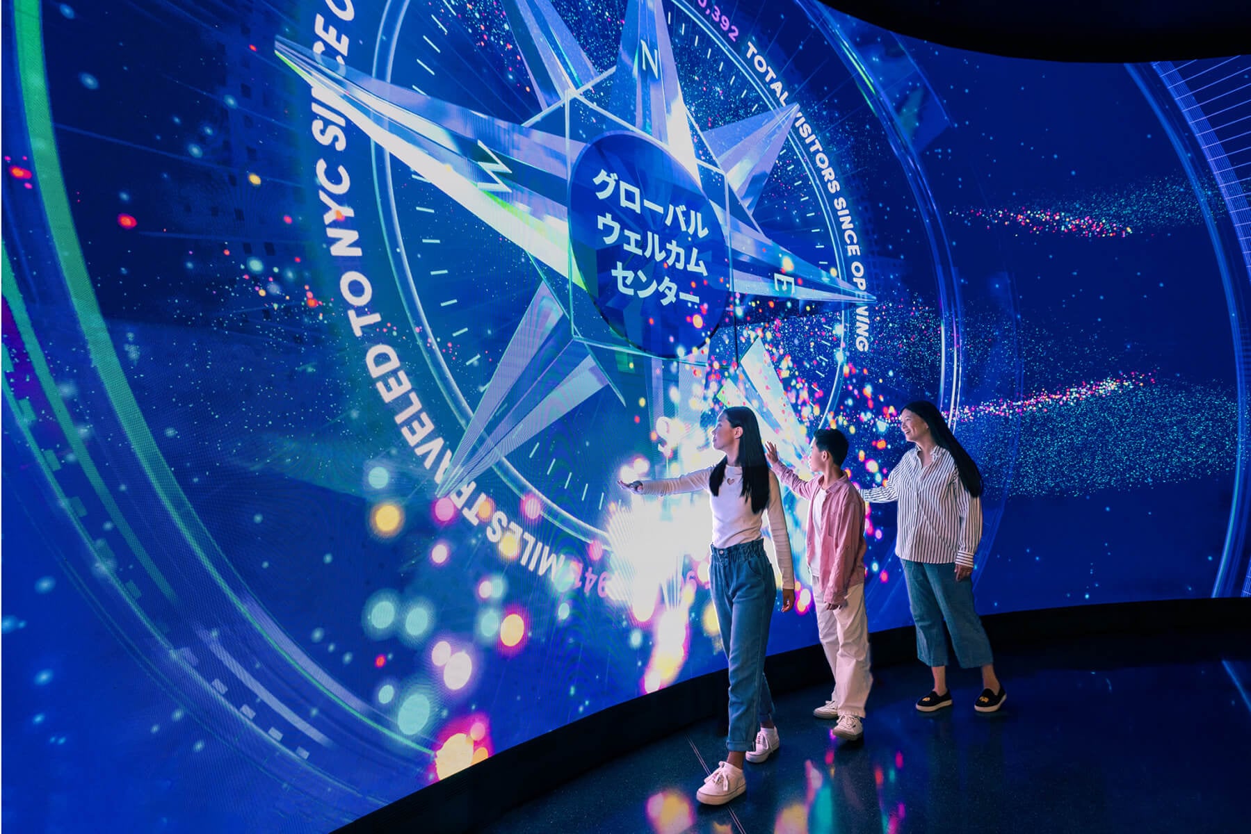 Visitors arriving at the welcome wall inside One World Observatory