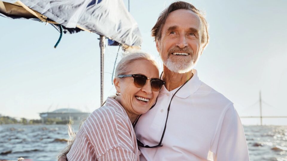 Mature couple enjoying a sunny sailing trip