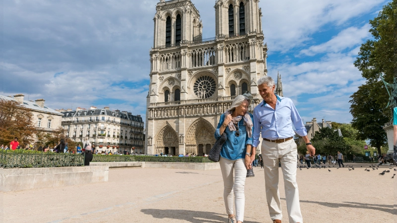 Older couple sightseeing in Paris, representing travel insurance for seniors