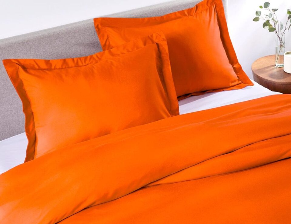 Sunkissed Orange duvet cover styled on a bed in a bedroom