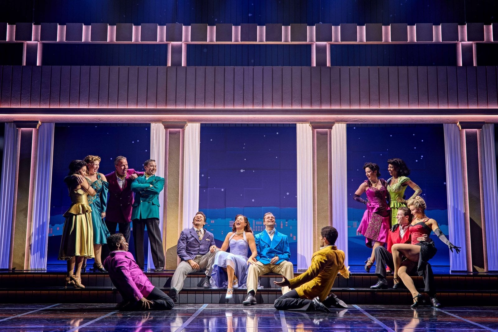 An ensemble cast performing on stage in Sinatra the Musical