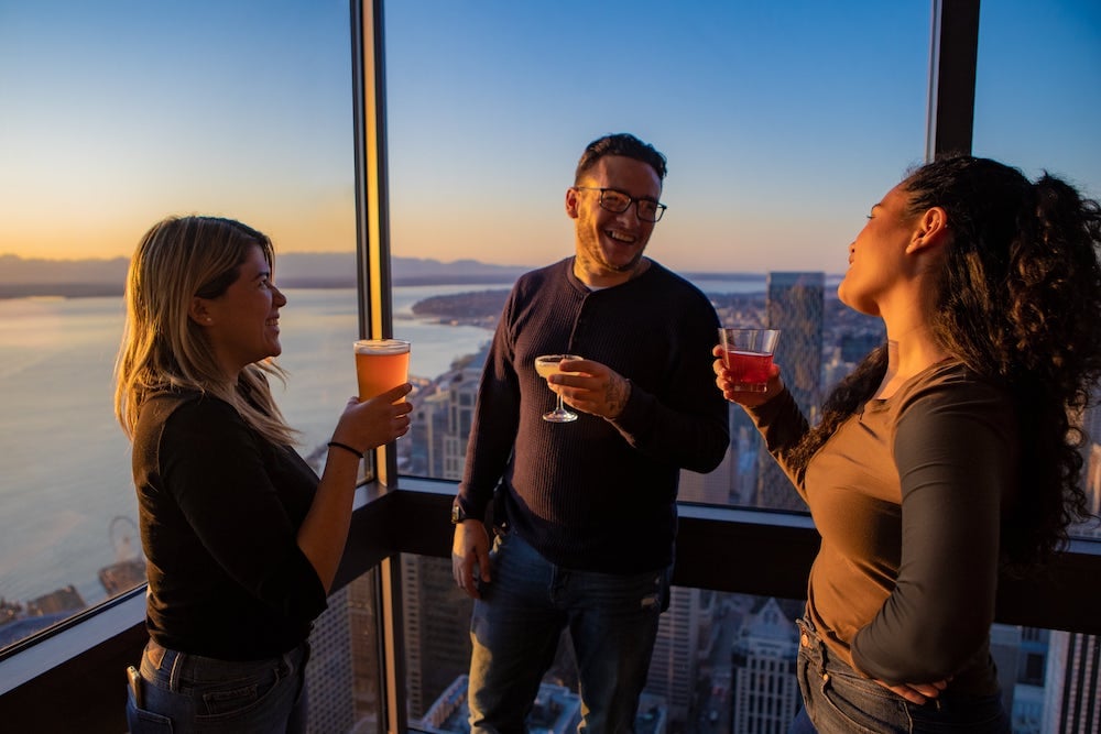 Visitors looking through windows inside Sky View Observatory