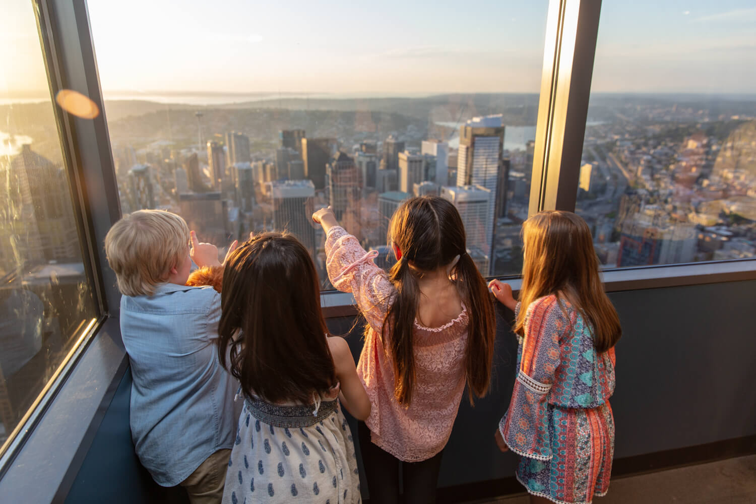 Guests taking in the Seattle skyline through observatory windows