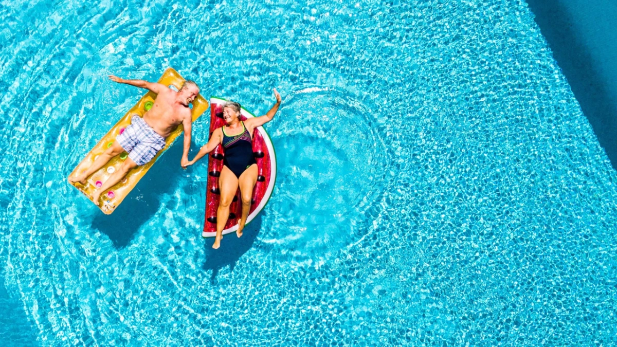 Mature couple enjoying a swimming pool on holiday