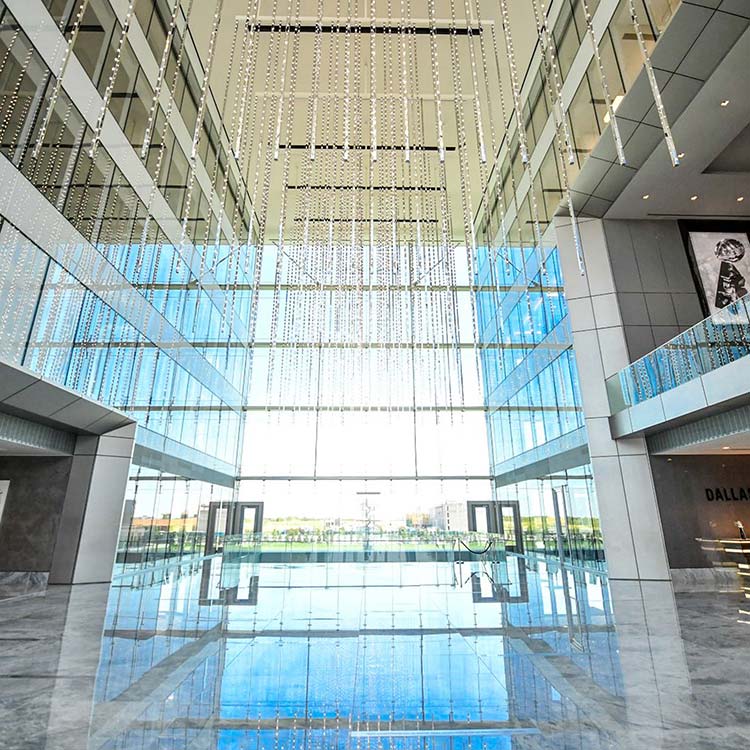 Visitors gathered in the glass lobby during a guided tour at The Star in Frisco