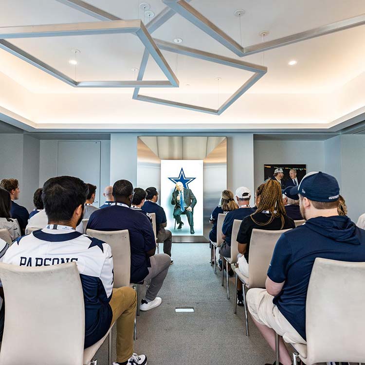 Tour group watching an interactive presentation during the Owners Experience Tour