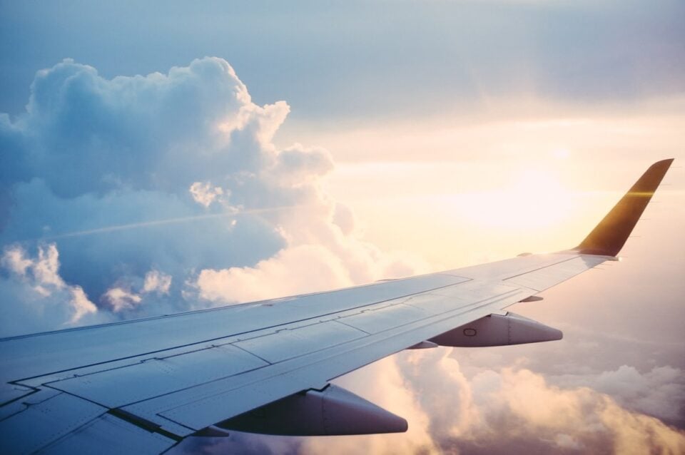 Passenger airplane flying above the clouds