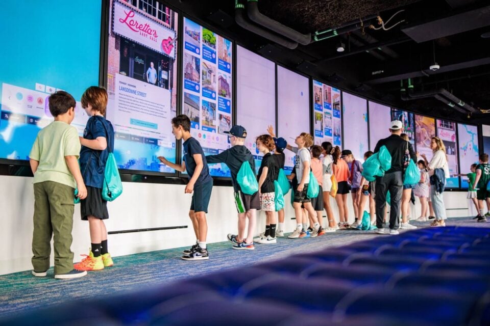 Children using interactive displays inside View Boston