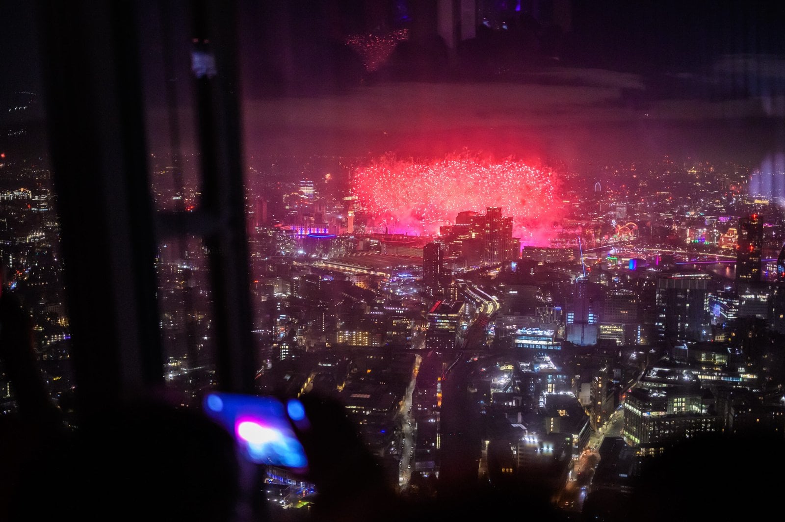 London skyline glowing at night from The Shard