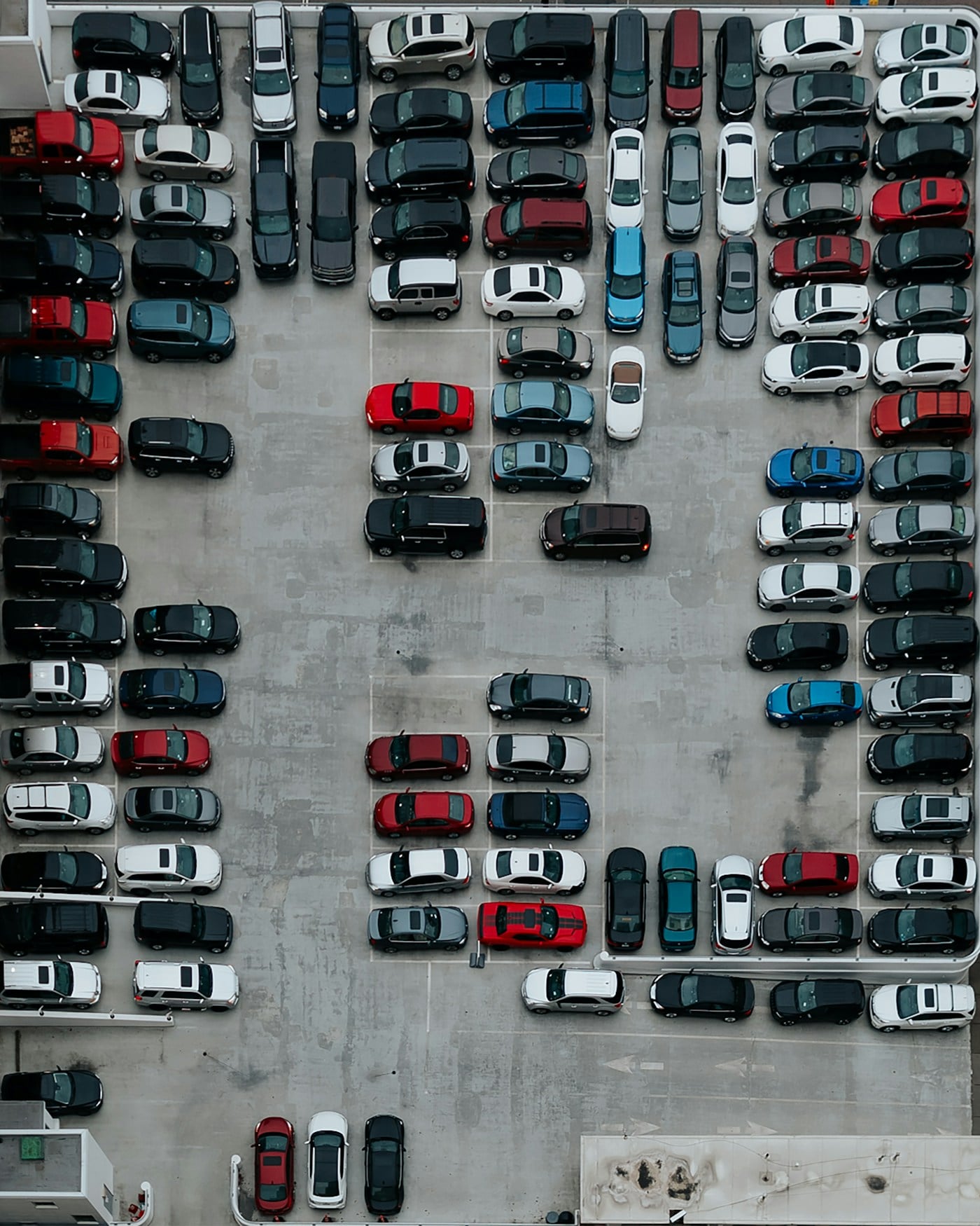 Aerial view of cars arranged in a parking lot