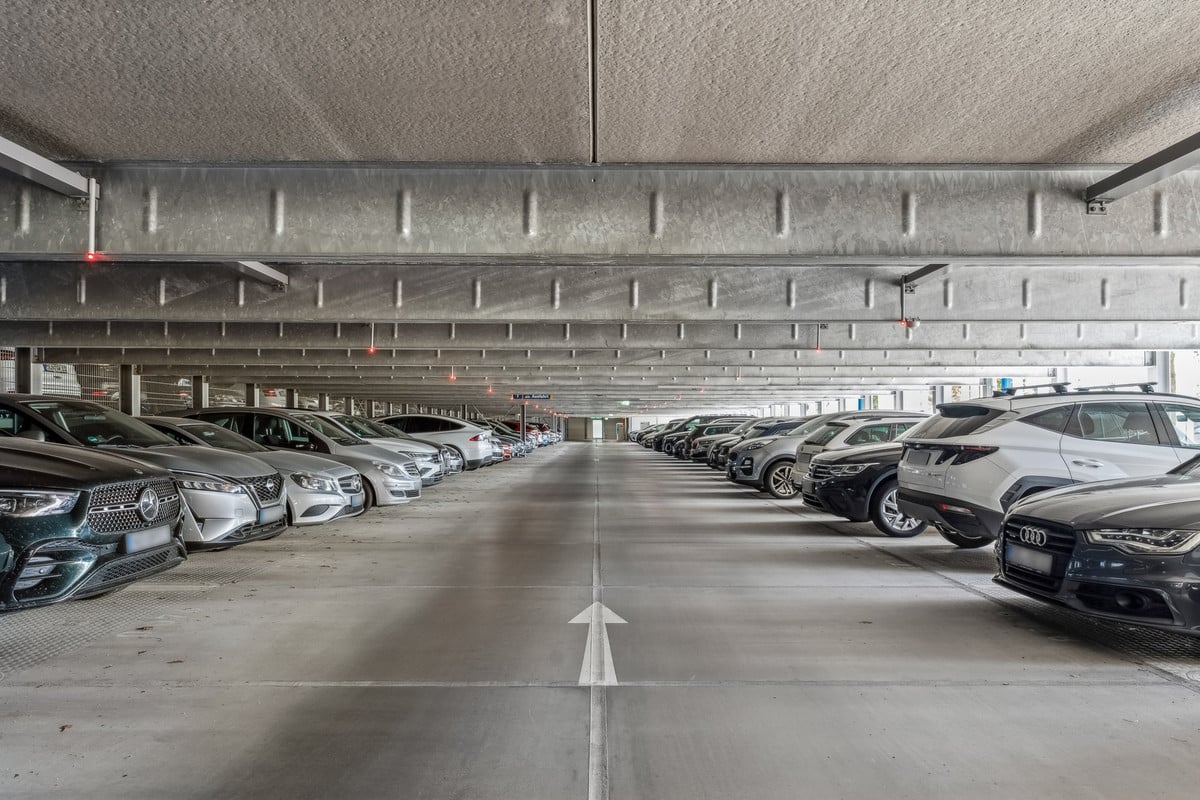 Rows of cars inside a multi-storey airport parking garage