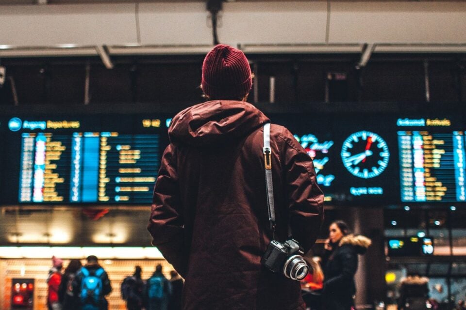 Traveller checking departure information on airport boards