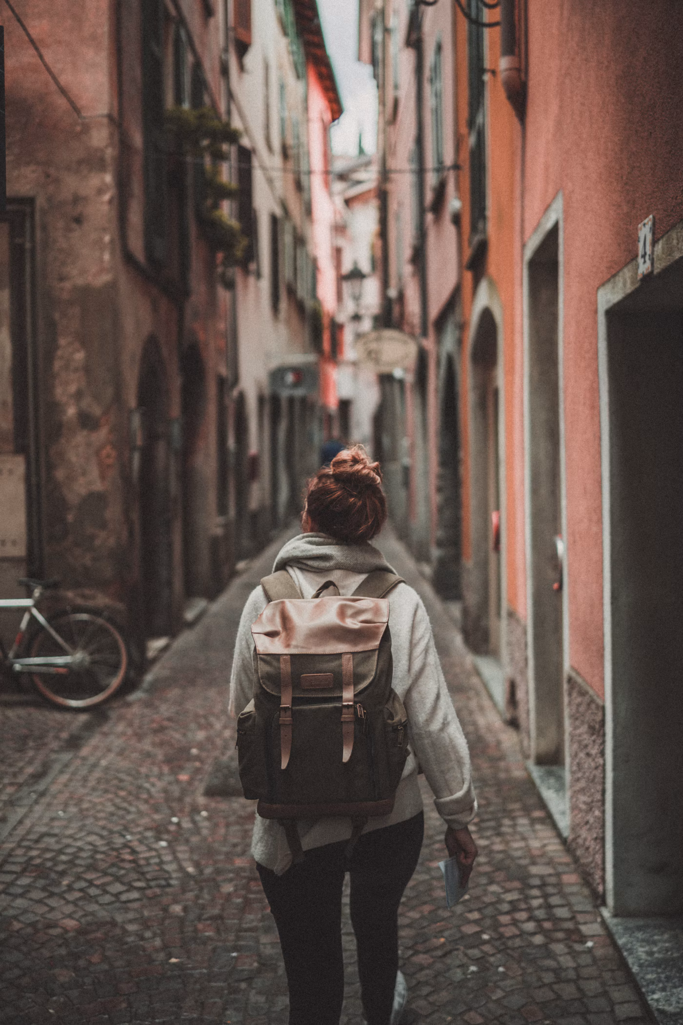 Traveller with a backpack walking along a city street