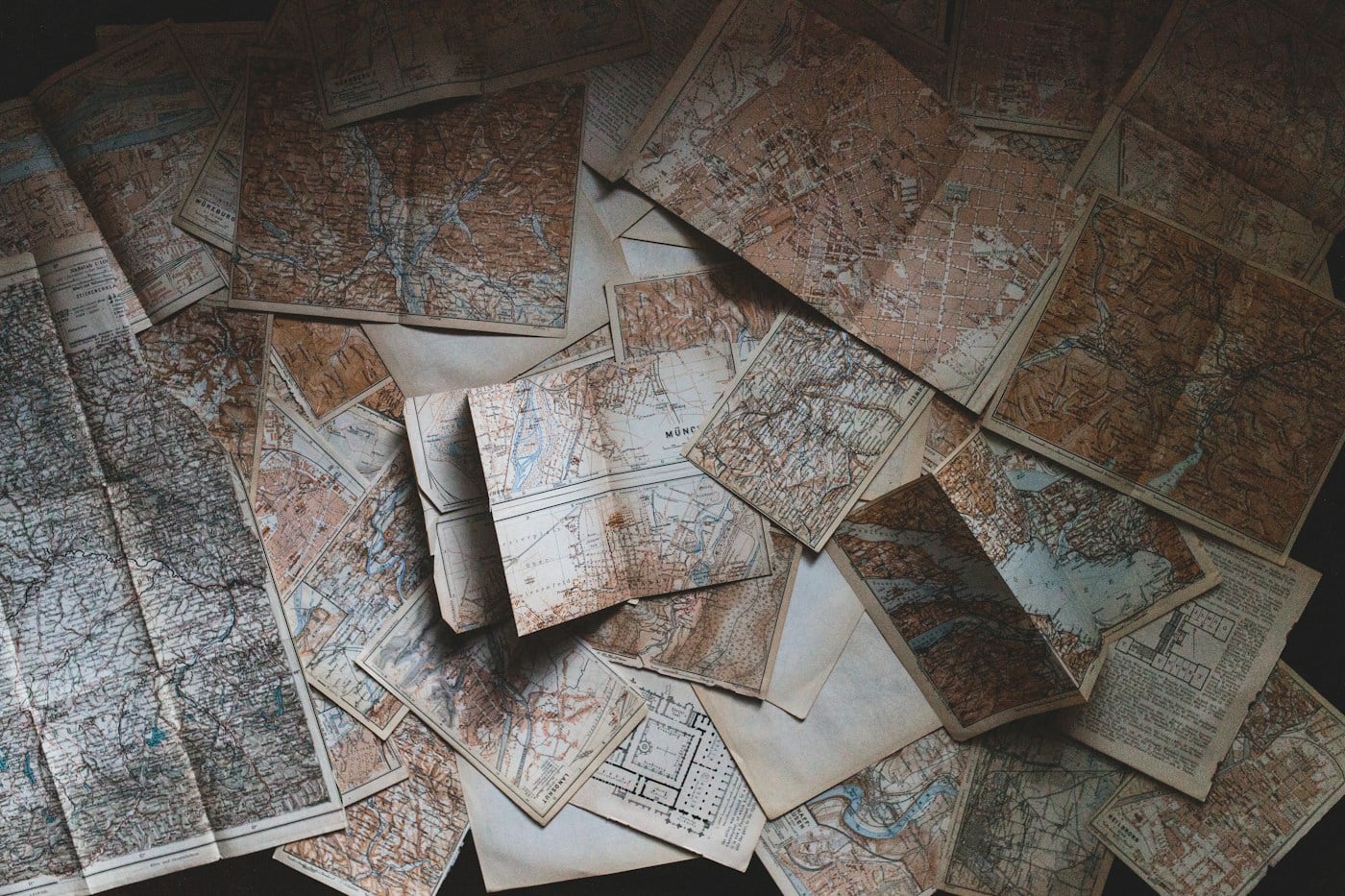 Vintage maps spread out for trip planning