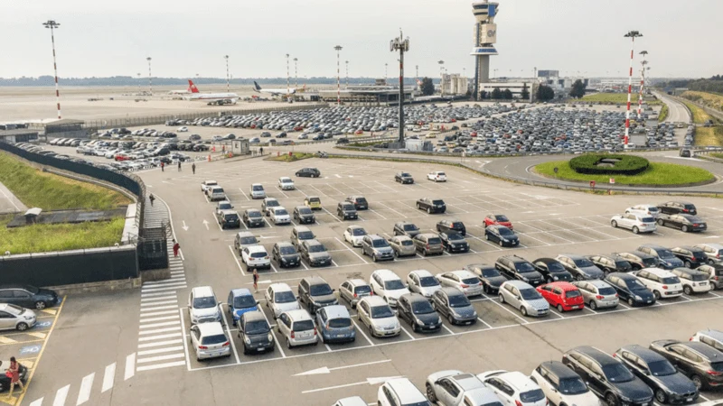 Cars and shuttle vehicles in an airport parking area