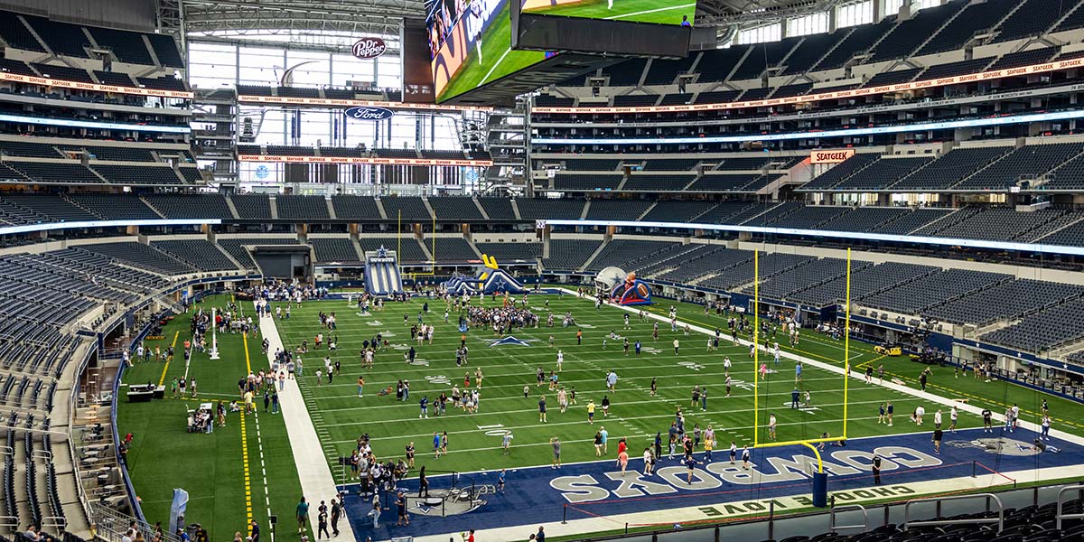 Wide interior view across AT&T Stadium and its field