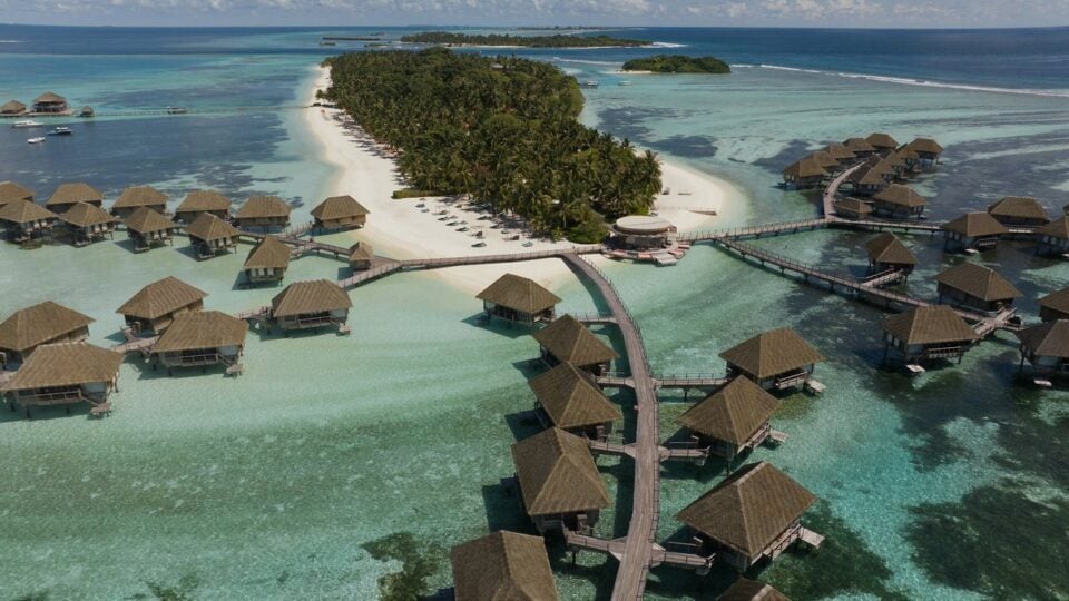 Aerial view of turquoise water and the island resort at Club Med Kani