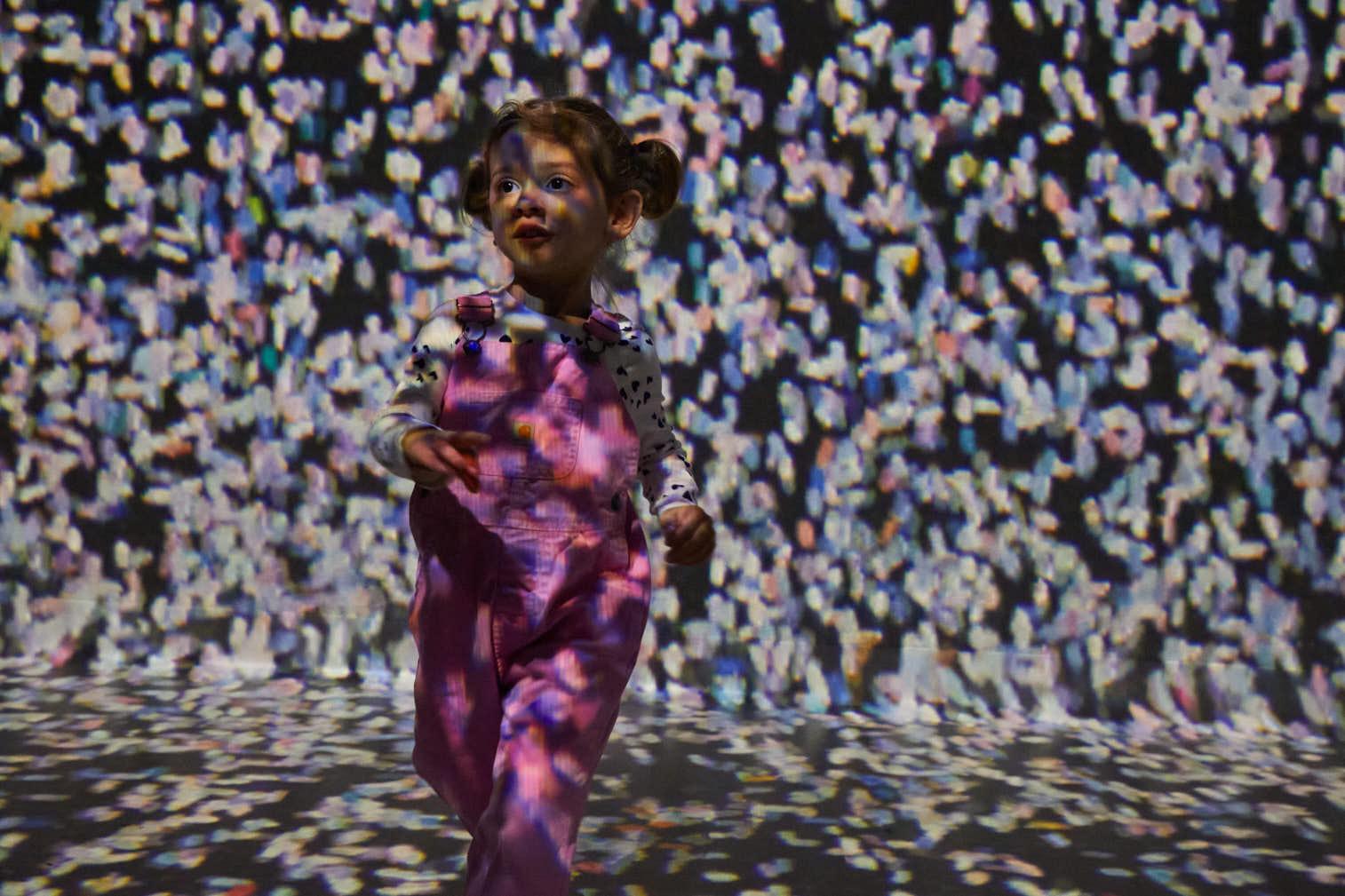 Child moving through the Frameless immersive galleries