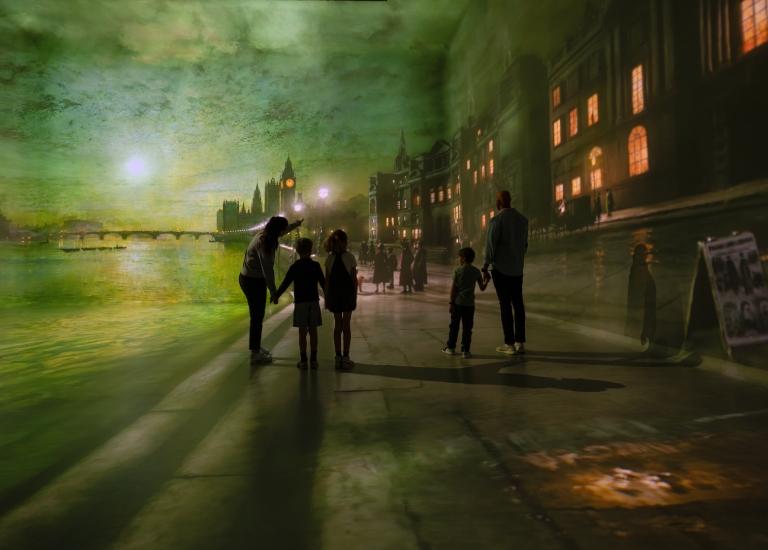 Families walking through a projected London scene at Frameless