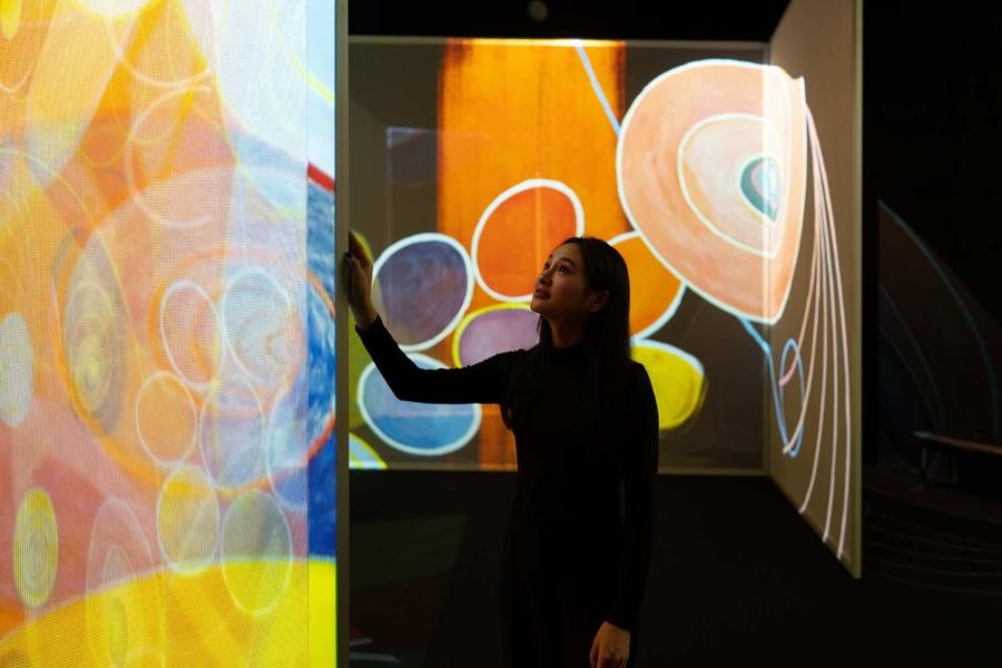 Student viewing projected abstraction at Frameless