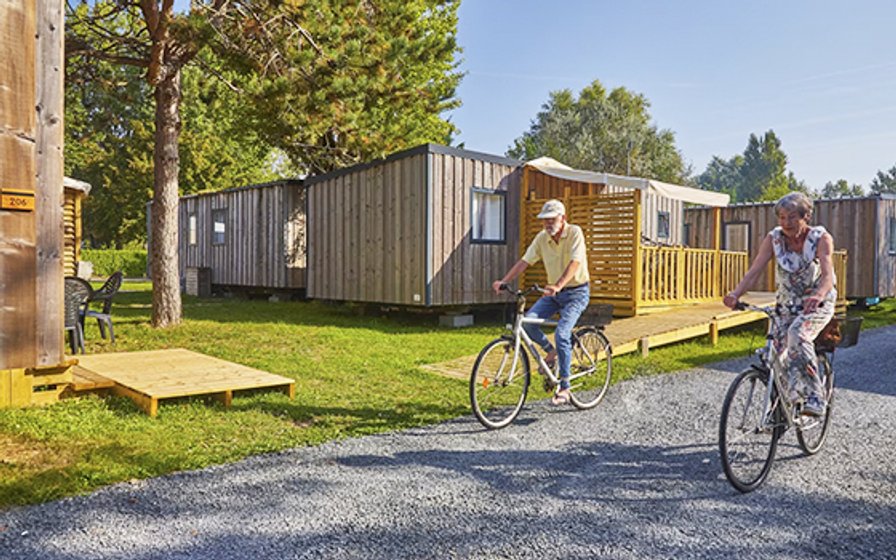 A couple cycling between holiday homes at Riva Bella
